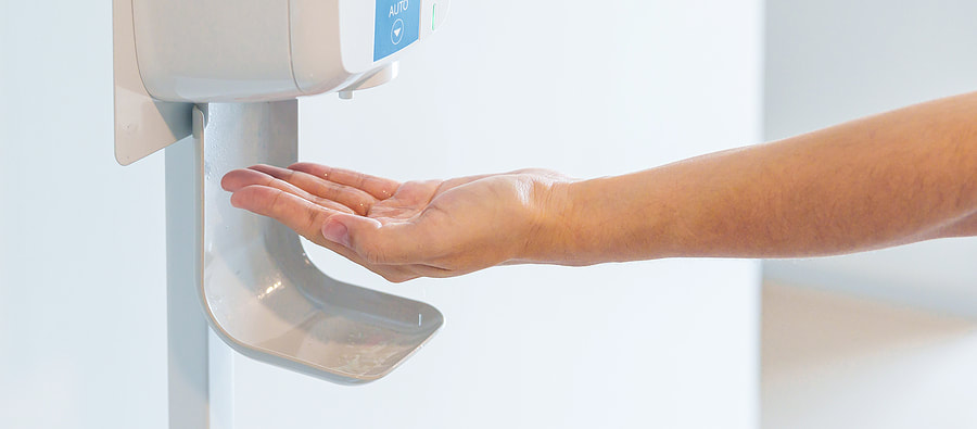 woman putting sanitizer in her hand